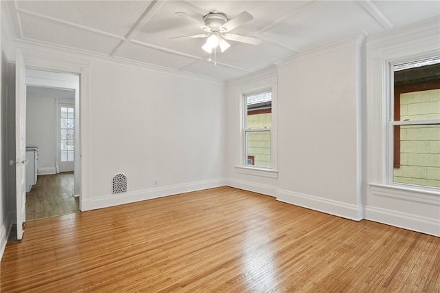 unfurnished room featuring coffered ceiling, a wealth of natural light, light hardwood / wood-style floors, and ceiling fan