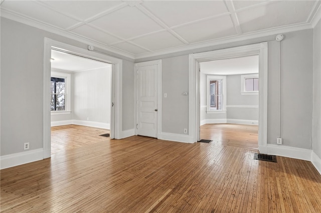 spare room with crown molding, coffered ceiling, and hardwood / wood-style floors