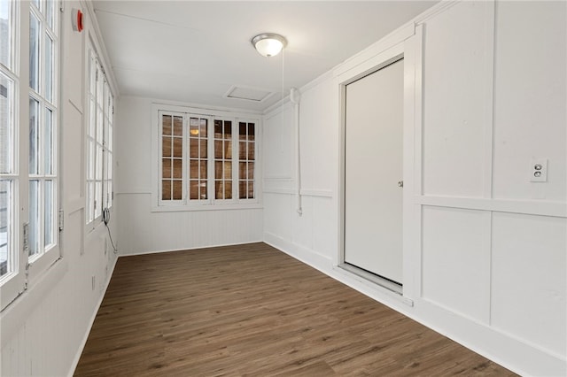 empty room with dark hardwood / wood-style flooring