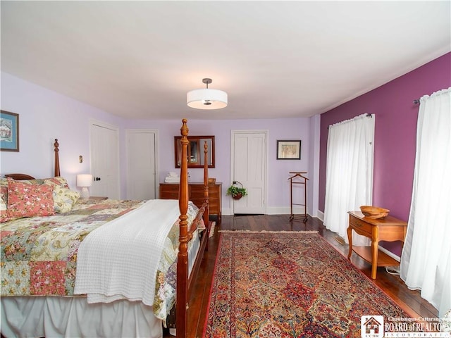 bedroom with dark hardwood / wood-style flooring