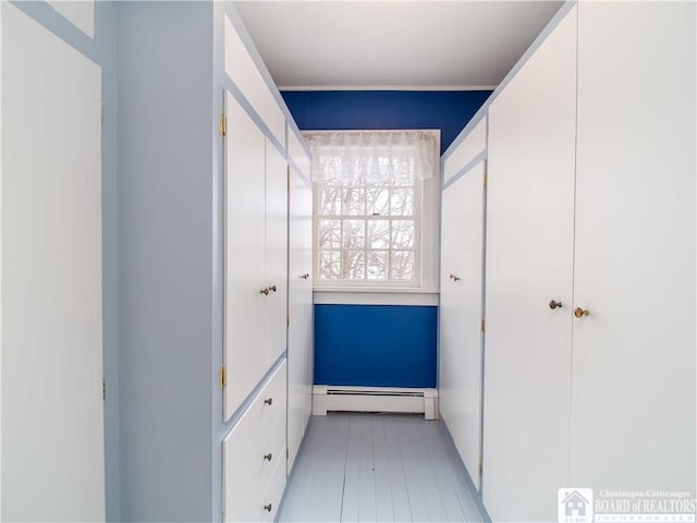 hallway with a baseboard heating unit