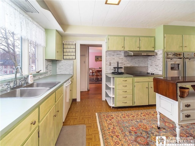 kitchen featuring sink, light parquet floors, dishwasher, range hood, and black electric cooktop