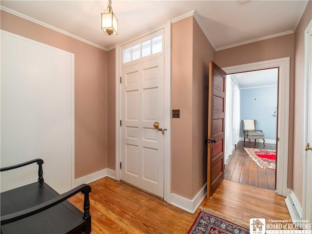 entrance foyer with ornamental molding and light wood-type flooring