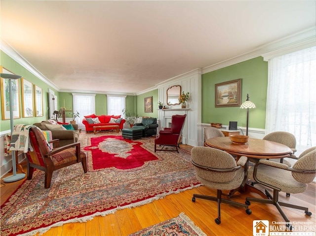 living room featuring hardwood / wood-style flooring and ornamental molding