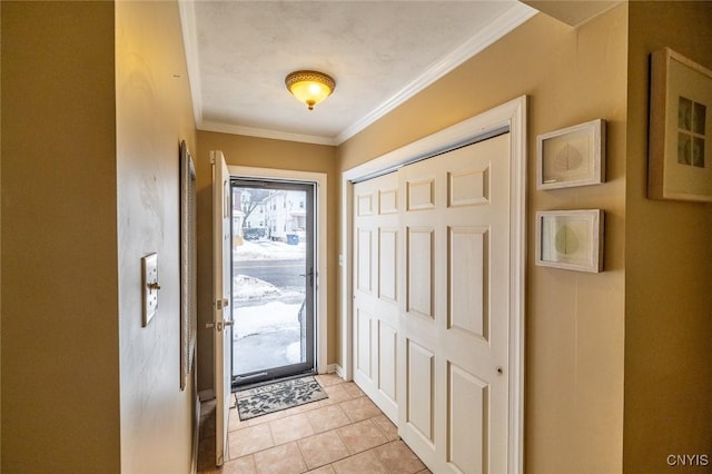 foyer entrance with ornamental molding and light tile patterned floors