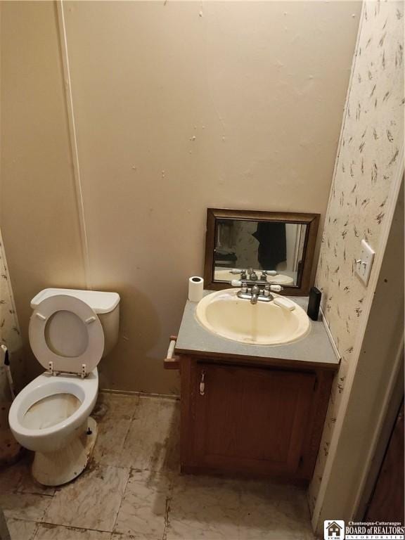 bathroom featuring vanity and toilet