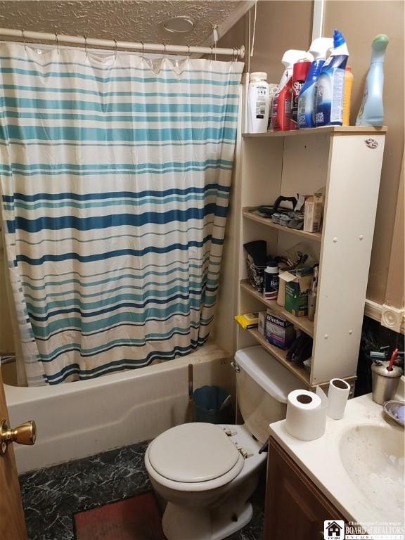 full bathroom with shower / tub combo, vanity, a textured ceiling, and toilet