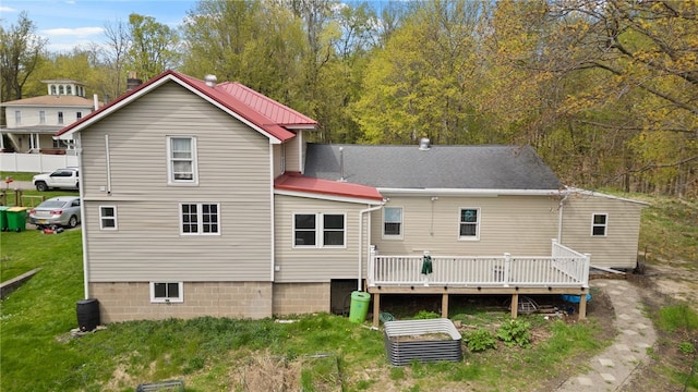rear view of house with a yard and a deck
