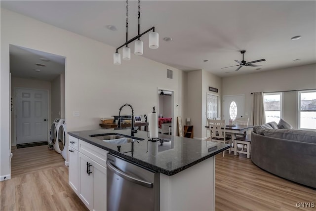 kitchen featuring a sink, separate washer and dryer, open floor plan, stainless steel dishwasher, and visible vents
