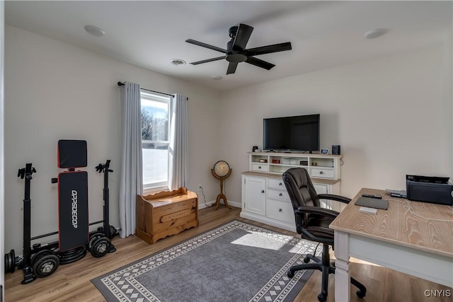 office area featuring a ceiling fan, baseboards, and wood finished floors