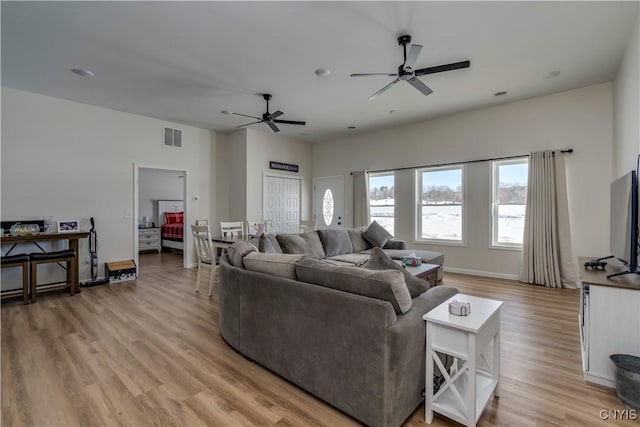 living area with a ceiling fan, light wood-type flooring, and visible vents