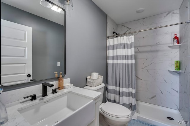 bathroom featuring toilet, a shower stall, marble finish floor, and vanity