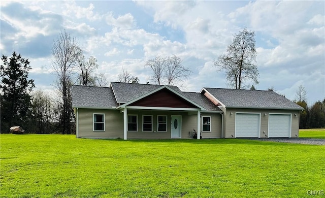 view of front of house featuring aphalt driveway, a shingled roof, a front yard, and a garage