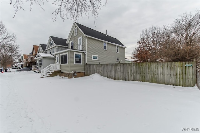 view of snow covered rear of property