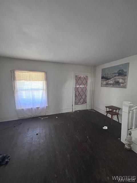 empty room featuring dark hardwood / wood-style flooring