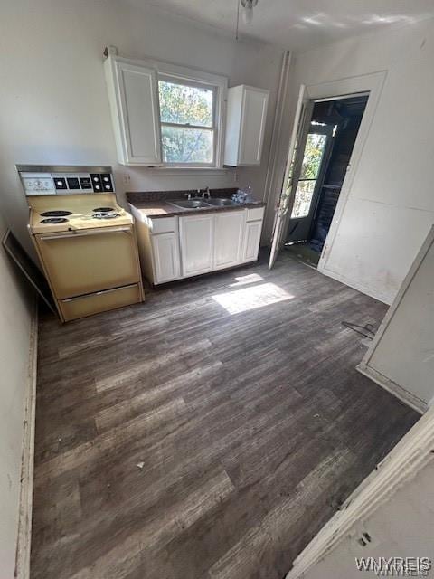 kitchen featuring white cabinetry, sink, dark wood-type flooring, and electric range