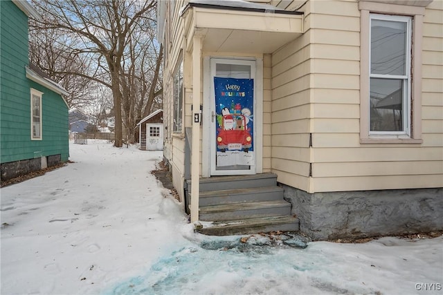 view of snow covered property entrance