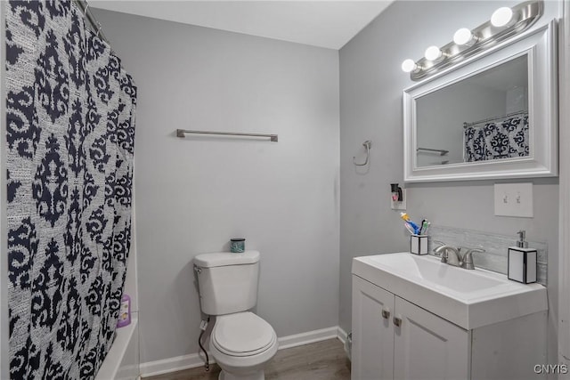 full bathroom featuring vanity, wood-type flooring, shower / tub combo with curtain, and toilet