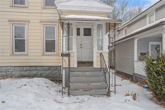 view of snow covered property entrance