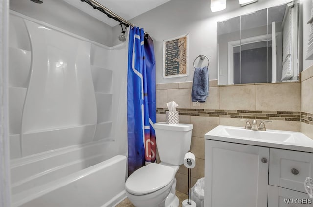 full bathroom featuring vanity, toilet, tile walls, and shower / bath combo