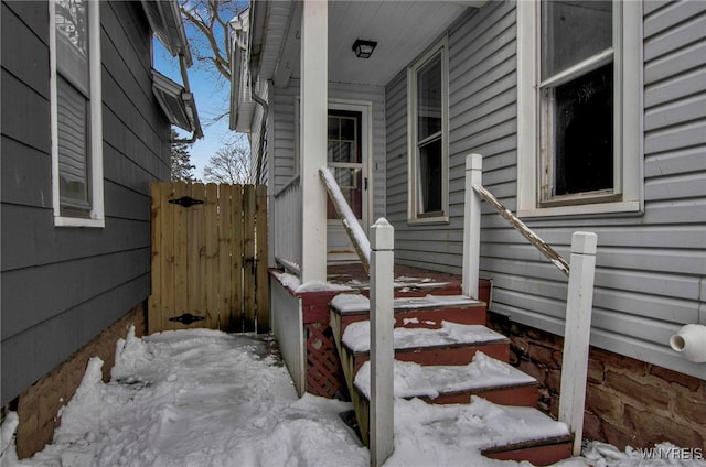 view of snow covered property entrance