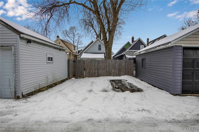 yard layered in snow with a garage