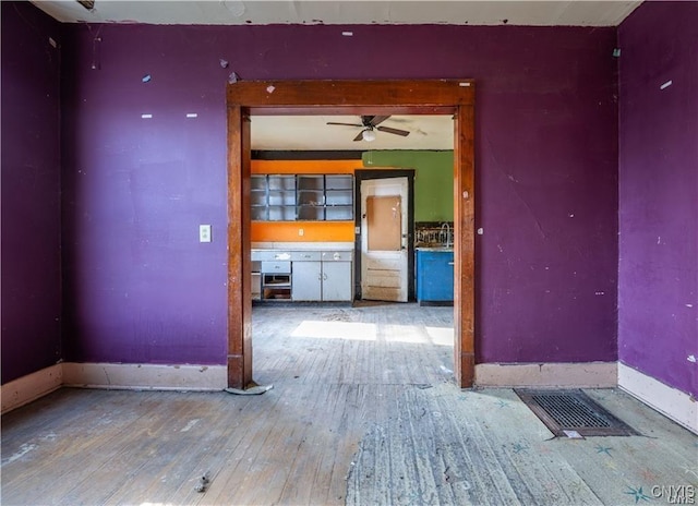 spare room featuring ceiling fan and hardwood / wood-style floors