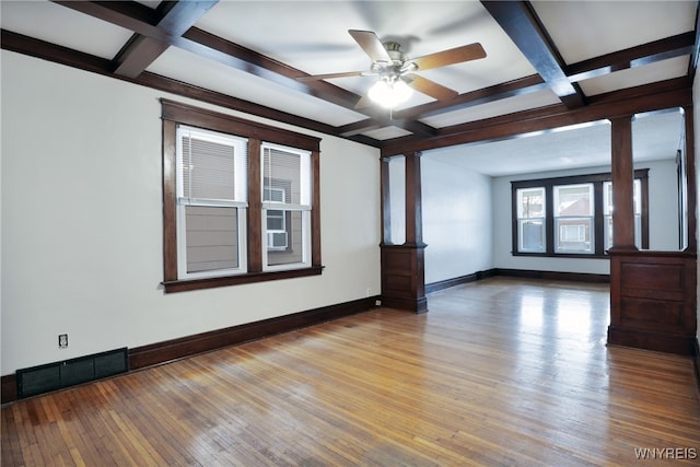 unfurnished room with coffered ceiling, beam ceiling, light hardwood / wood-style floors, and ornate columns