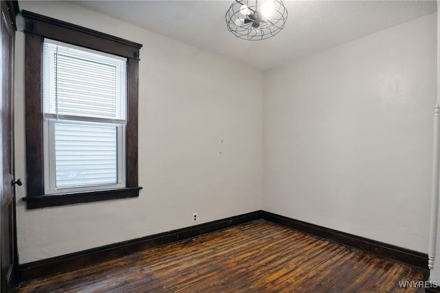 spare room featuring dark hardwood / wood-style floors