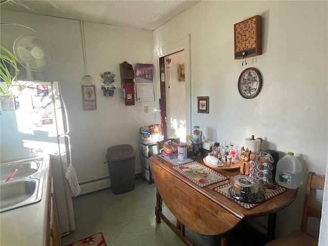 dining space featuring sink and baseboard heating