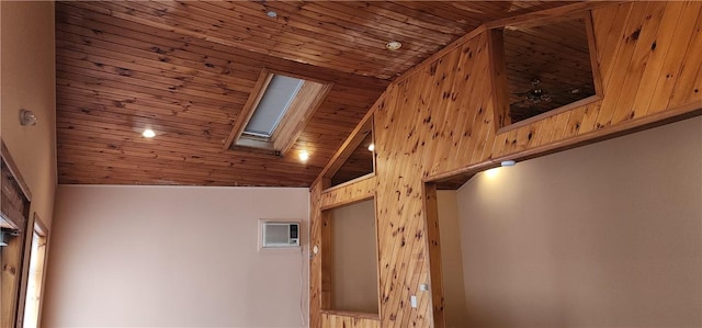 room details with wood ceiling, ceiling fan, a wall mounted air conditioner, and a skylight