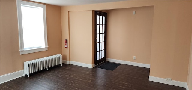 doorway featuring radiator heating unit and dark hardwood / wood-style flooring