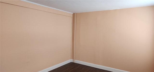 empty room with dark hardwood / wood-style floors