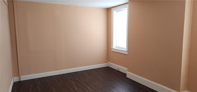 unfurnished room with dark hardwood / wood-style flooring