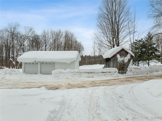 yard layered in snow featuring an outdoor structure