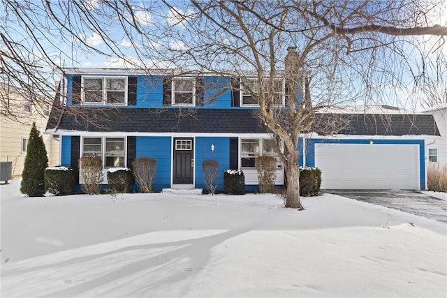 view of front of house featuring a garage and central air condition unit