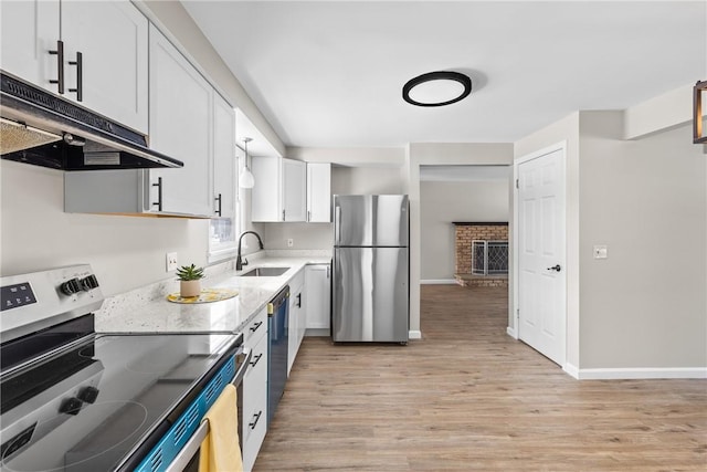 kitchen featuring white cabinetry, sink, light hardwood / wood-style flooring, and stainless steel appliances