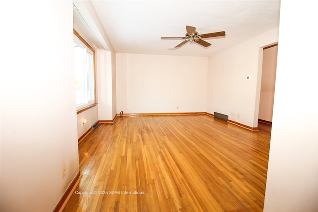 empty room with ceiling fan and light wood-type flooring