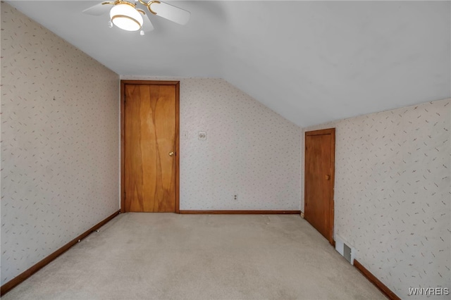 bonus room featuring vaulted ceiling, light colored carpet, and ceiling fan