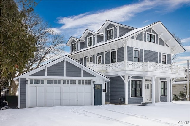 view of front facade featuring a balcony and a garage