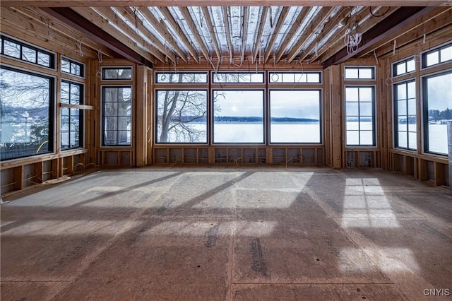 unfurnished sunroom with a water view