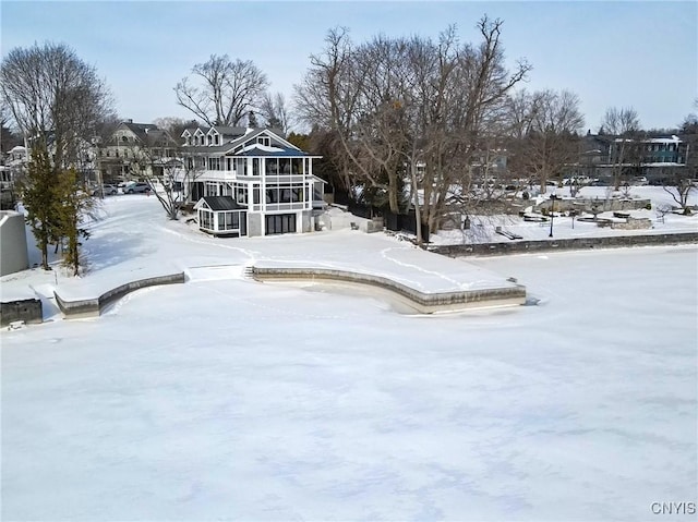 view of snow covered back of property