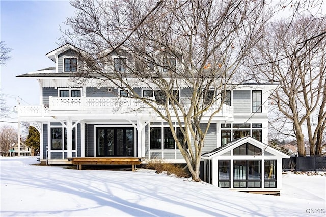 snow covered property featuring a balcony