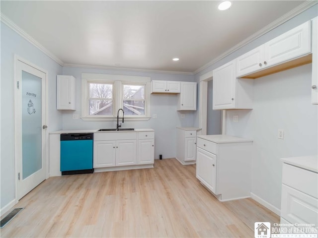 kitchen featuring black dishwasher, sink, and white cabinets