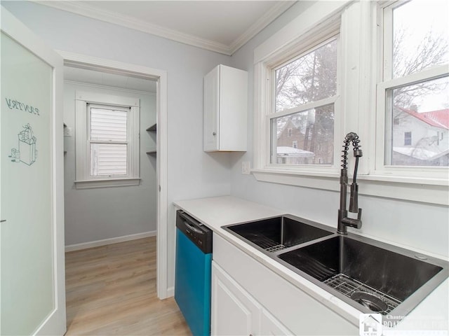 kitchen with crown molding, dishwasher, sink, and white cabinets