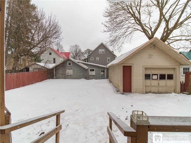 yard layered in snow with a garage