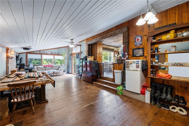 dining area featuring hardwood / wood-style flooring, wood ceiling, vaulted ceiling, and wood walls