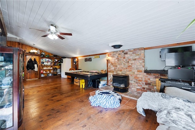 game room featuring lofted ceiling, ceiling fan, wood-type flooring, pool table, and a wood stove