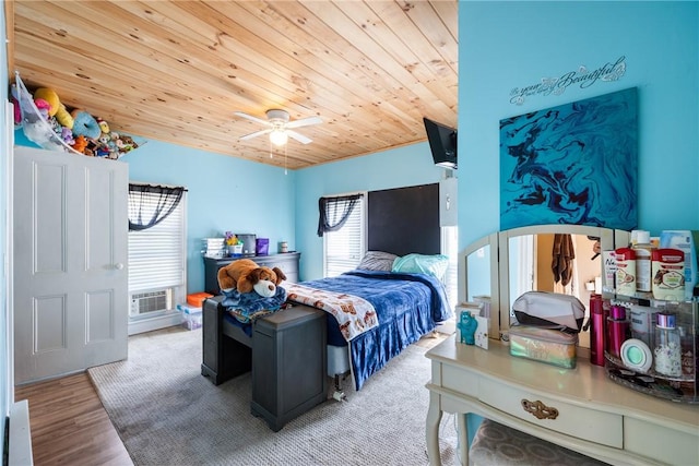 bedroom with ceiling fan, wooden ceiling, and light wood-type flooring