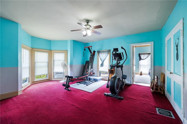 workout area featuring carpet flooring and ceiling fan